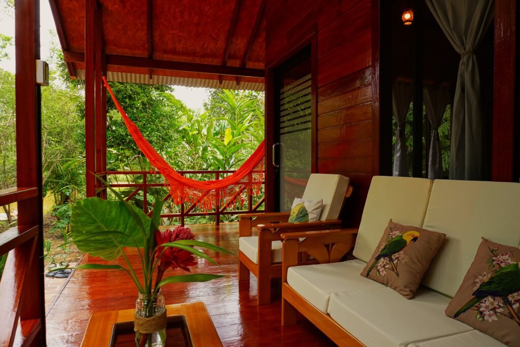 Private wooden terrace with hammock and lounge chairs surrounded by tropical vegetation at Amazon Passiflora Lodge in the Peruvian Amazon