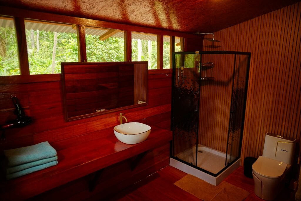 Private eco-friendly bathroom with modern shower and wooden design at an eco lodge in the Peruvian Amazon